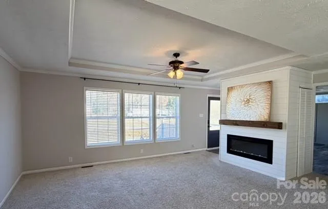 a view of empty room with fireplace and fan