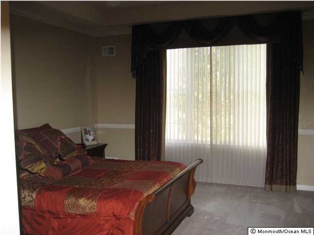 23 Shoal Road Jackson, NJ 08527 - Photo 11 of 21 a bed sitting in a bedroom next to a window