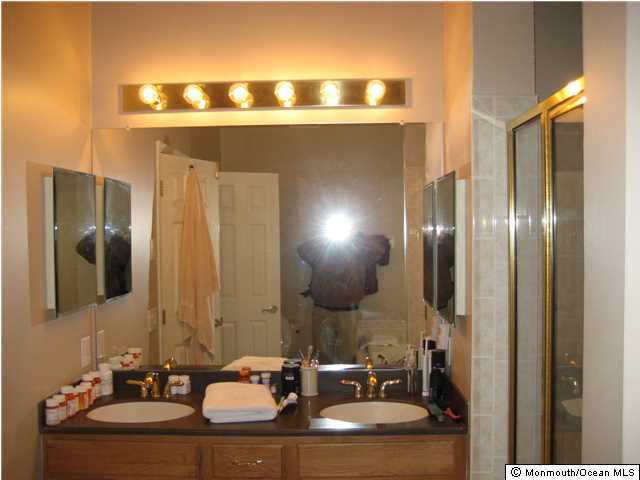 23 Shoal Road Jackson, NJ 08527 - Photo 12 of 21 a bathroom with a sink and a mirror