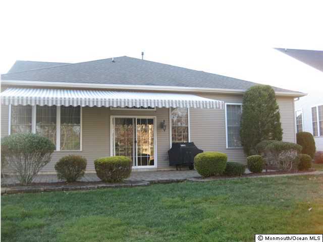 23 Shoal Road Jackson, NJ 08527 - Photo 2 of 21 a front view of a house with a garden