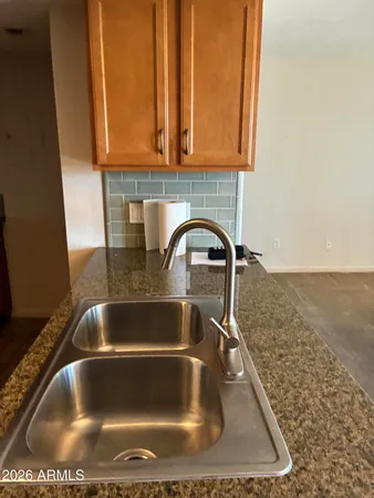a bathroom with a granite countertop toilet sink and mirror
