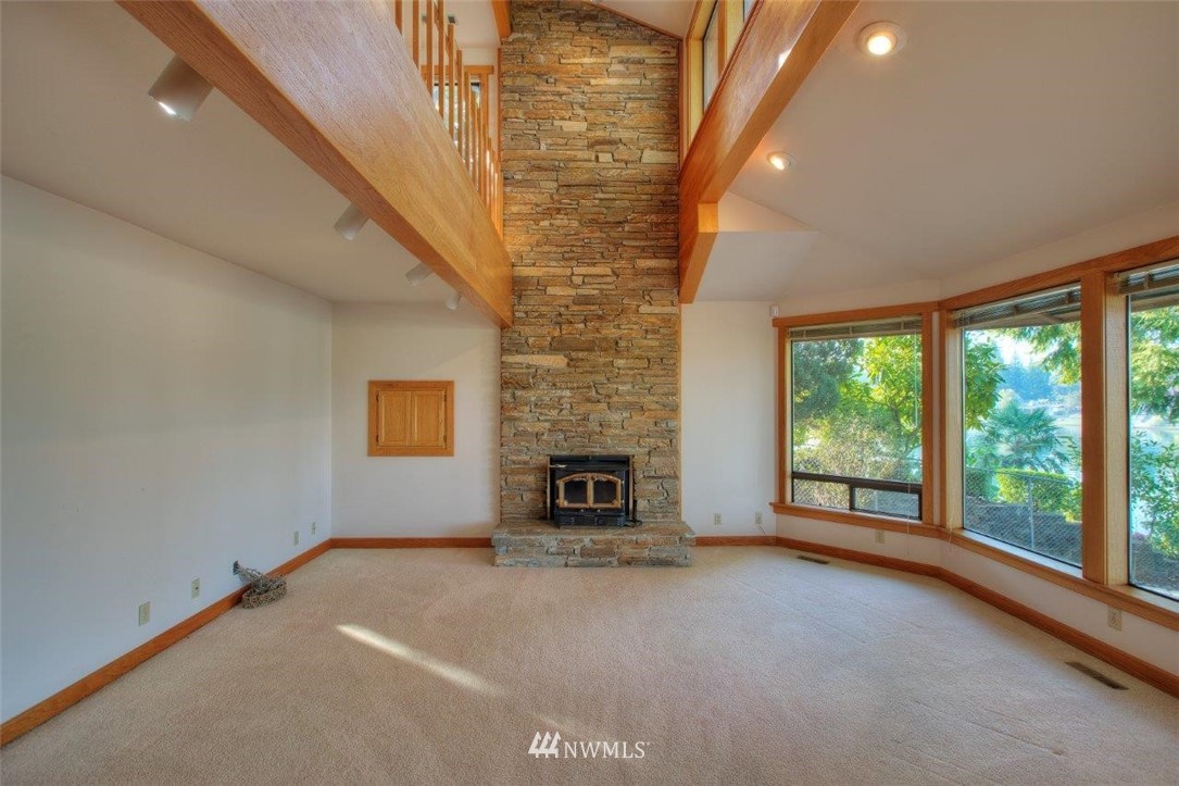 1822 Channel Road East Lake Tapps, WA 98391 - Photo 13 of 38 a view of a livingroom with furniture fireplace and window