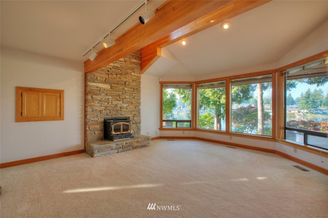 1822 Channel Road East Lake Tapps, WA 98391 - Photo 14 of 38 a view of an empty room with a fireplace and a window