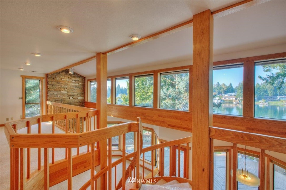 1822 Channel Road East Lake Tapps, WA 98391 - Photo 19 of 38 a view of an empty room with wooden floor and windows