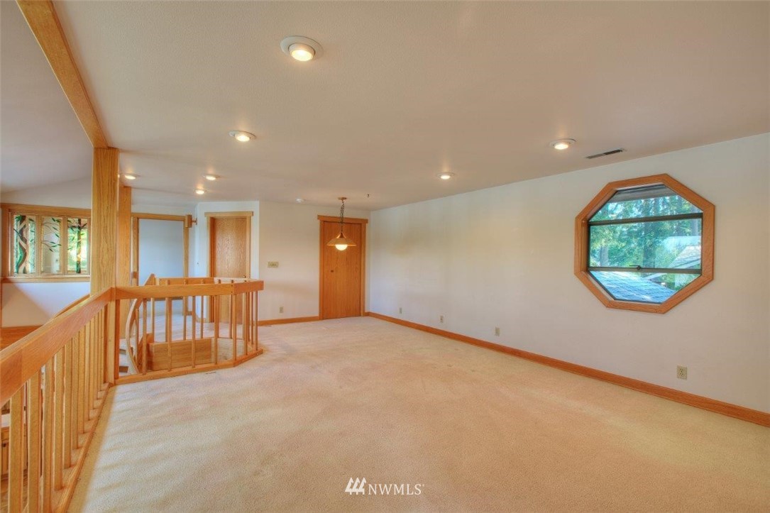 1822 Channel Road East Lake Tapps, WA 98391 - Photo 20 of 38 an empty room with a window and a couch