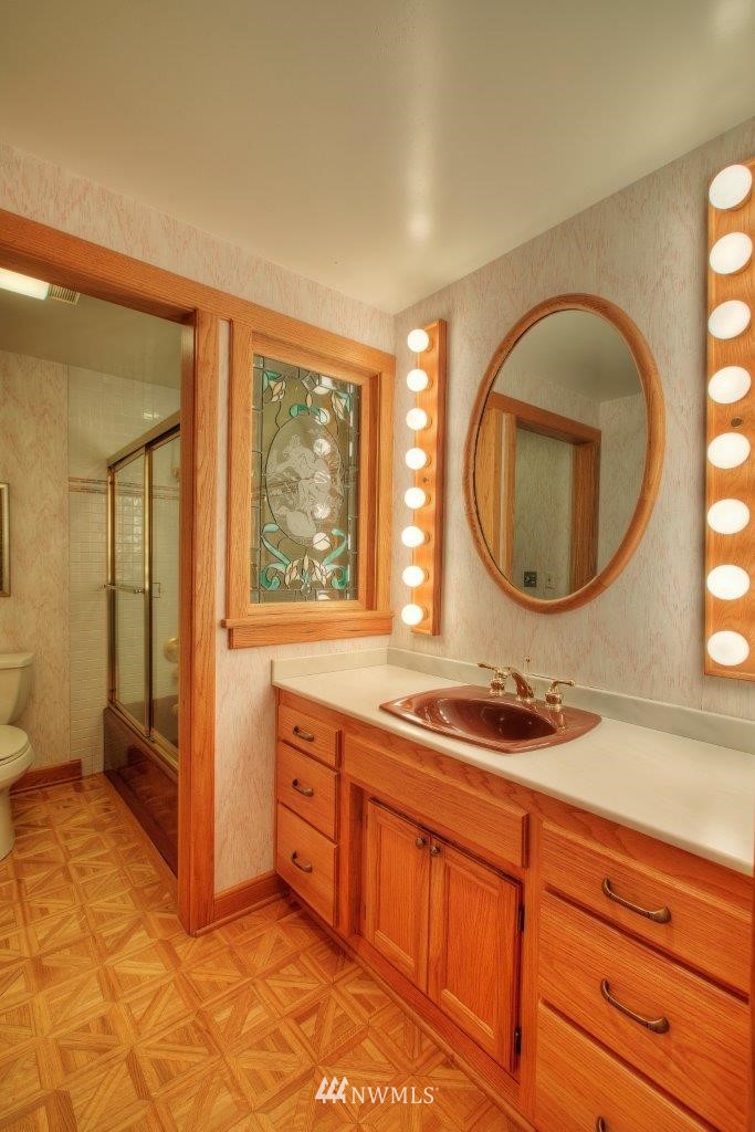 1822 Channel Road East Lake Tapps, WA 98391 - Photo 26 of 38 a bathroom with a sink and a mirror