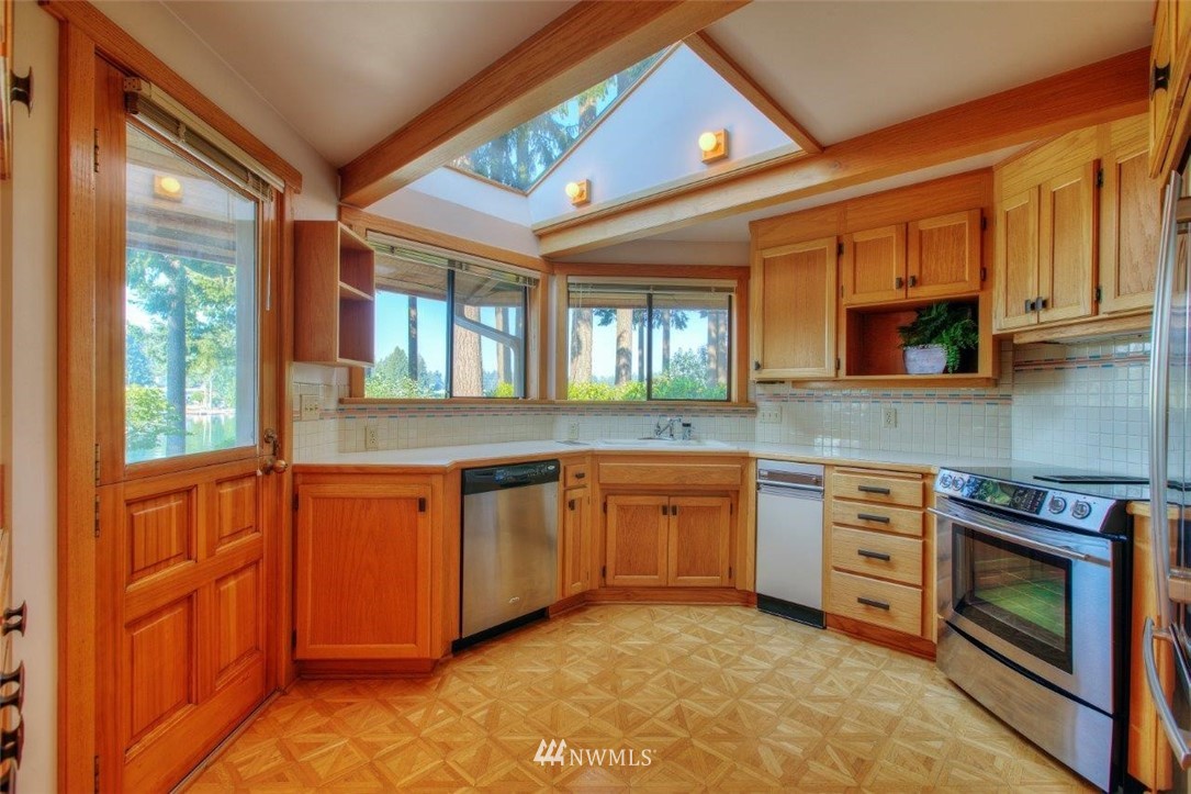 1822 Channel Road East Lake Tapps, WA 98391 - Photo 7 of 38 a kitchen with stainless steel appliances granite countertop a stove and a sink