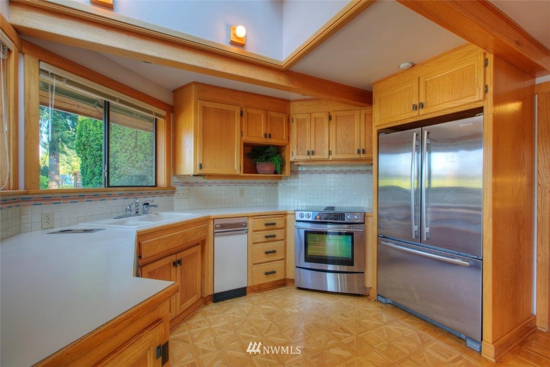 1822 Channel Road East Lake Tapps, WA 98391 - Photo 8 of 38 a kitchen with stainless steel appliances granite countertop a refrigerator and a stove top oven