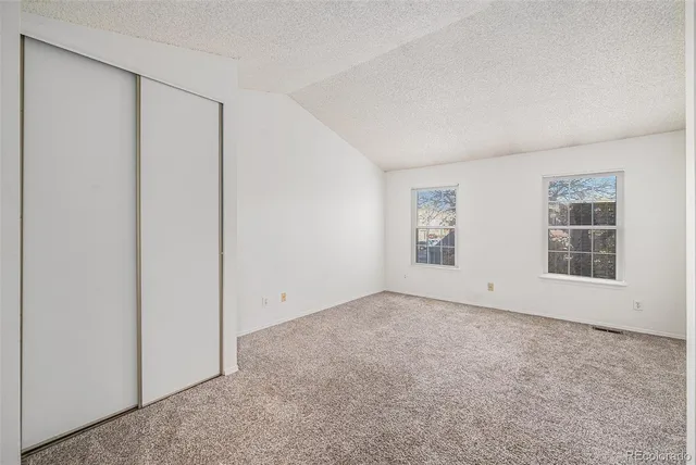 a view of an empty room and closet area
