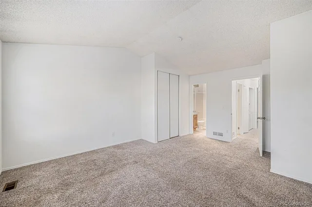 a bathroom with a granite countertop sink a mirror and a bathtub