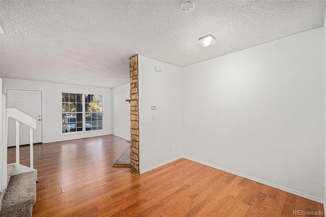 a view of a kitchen with wooden floor and a sink