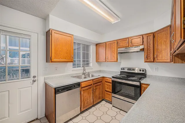a kitchen with stainless steel appliances granite countertop a stove a sink dishwasher and a refrigerator