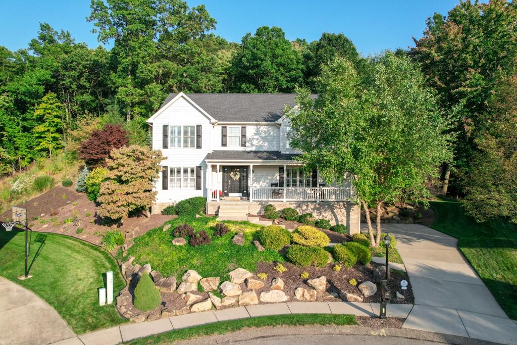 a front view of a house with a garden