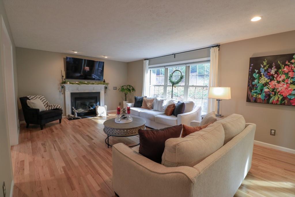 549 Dorchester Drive Seven Fields, PA 16046 - Photo 11 of 35 a living room with fireplace furniture and a flat screen tv