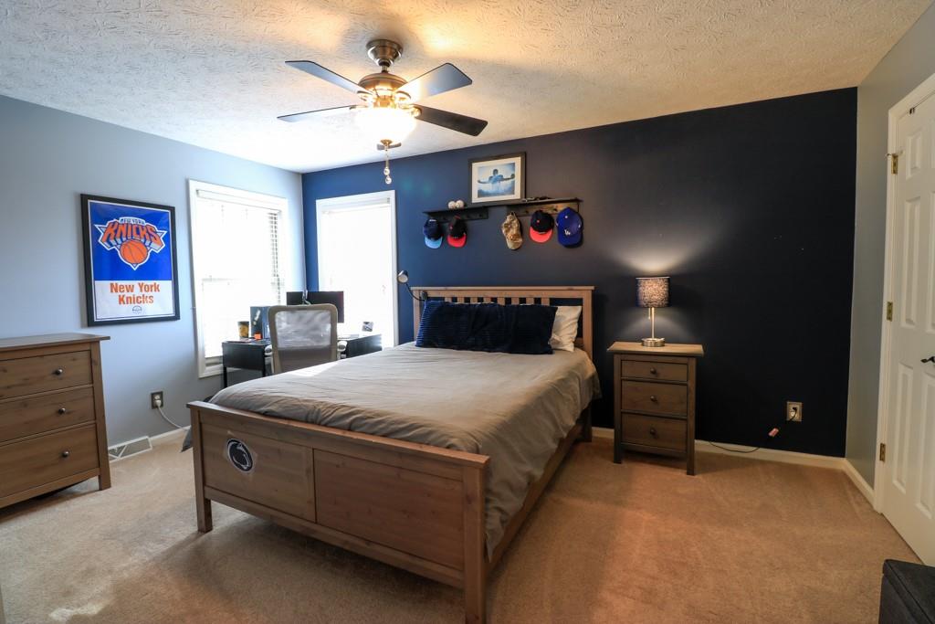 549 Dorchester Drive Seven Fields, PA 16046 - Photo 20 of 35 a bedroom with a bed and a chandelier