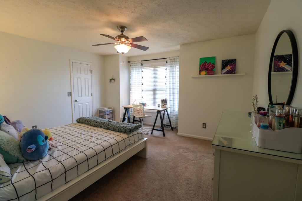 549 Dorchester Drive Seven Fields, PA 16046 - Photo 21 of 35 a bedroom with a bed and a chandelier