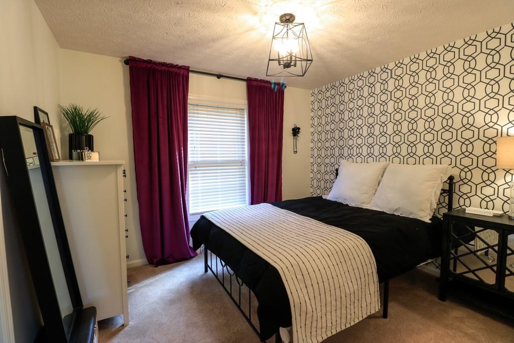 549 Dorchester Drive Seven Fields, PA 16046 - Photo 22 of 35 a bedroom with a bed and a mirror