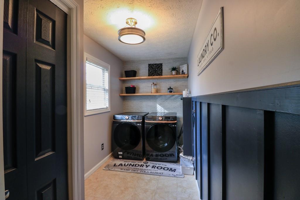 549 Dorchester Drive Seven Fields, PA 16046 - Photo 9 of 35 a kitchen with stainless steel appliances granite countertop a refrigerator a stove and a sink with large cabinets