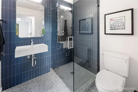 a bathroom with a toilet sink and shower