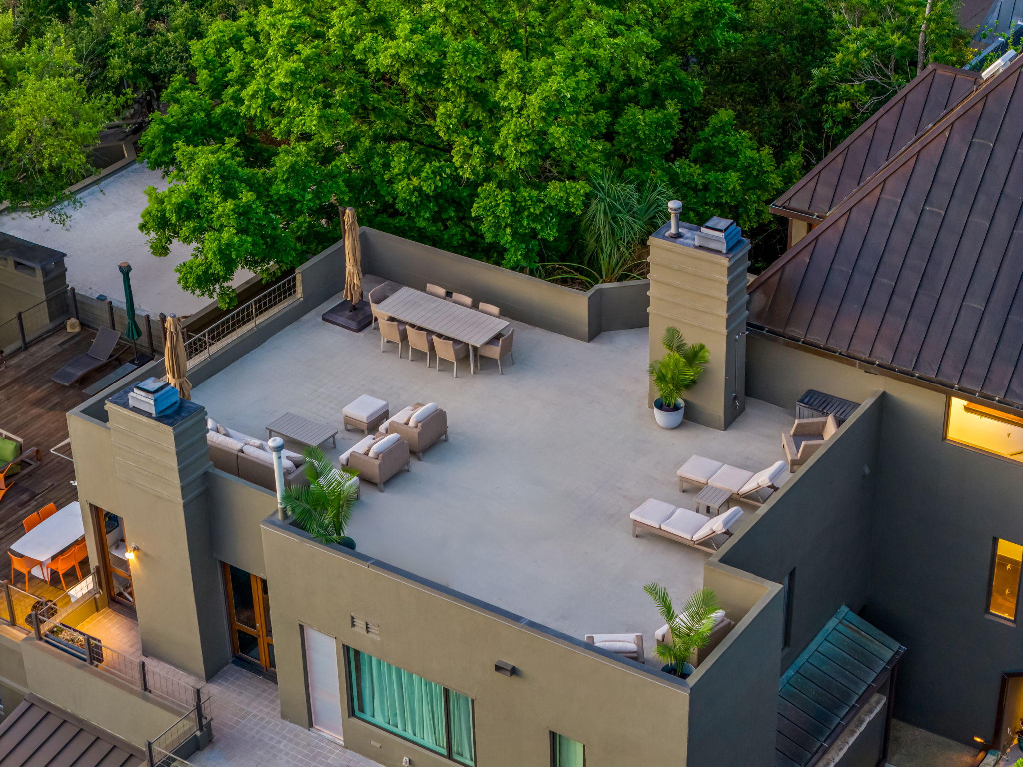 1111 West 12th Street, Unit 107 Austin, TX 78703 - Photo 3 of 38 Expansive rooftop terrace with multiple seating areas, including a dining space, lounge seating, and sun loungers