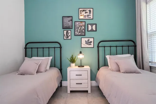 a bedroom with furniture and a window