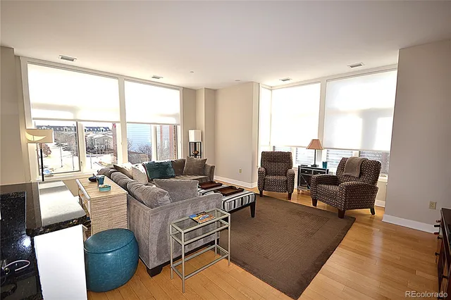 a spacious bathroom with a double vanity sink a large mirror and toilet