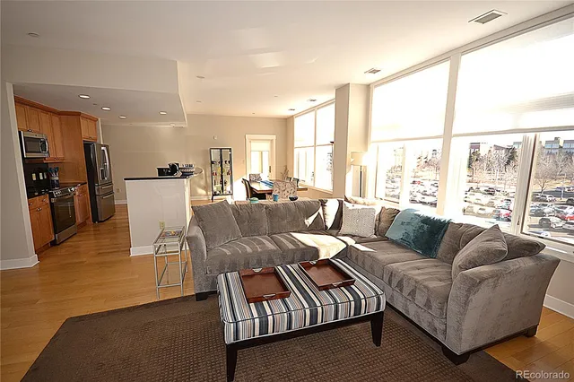 a bedroom with a bed lamp on desk and a window