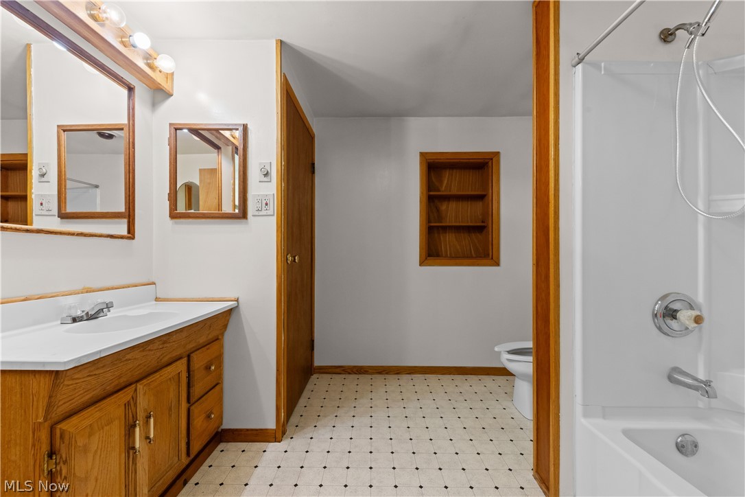 409 Edith Avenue Akron, OH 44312 - Photo 19 of 45 Bathroom featuring a wood-finish vanity with an integrated sink, white countertop, and chrome faucet