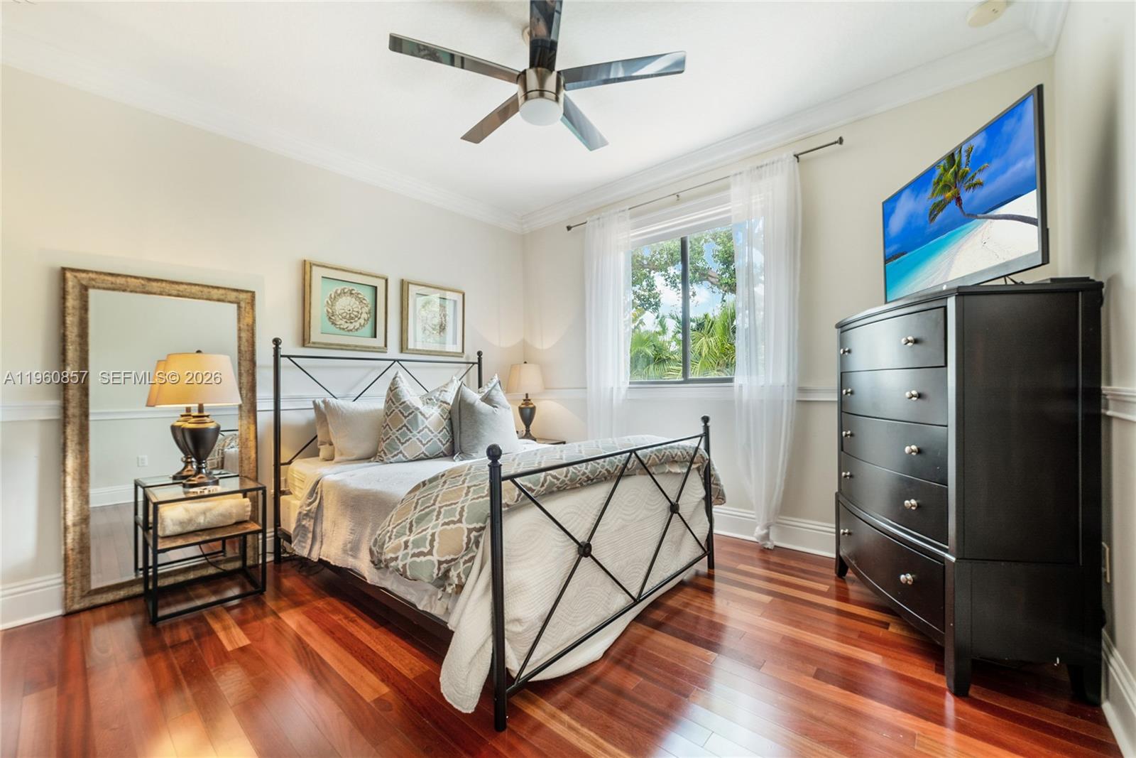 5621 Southwest 68th Court Miami, FL 33143 - Photo 17 of 18 a bedroom with a bed dresser and a window