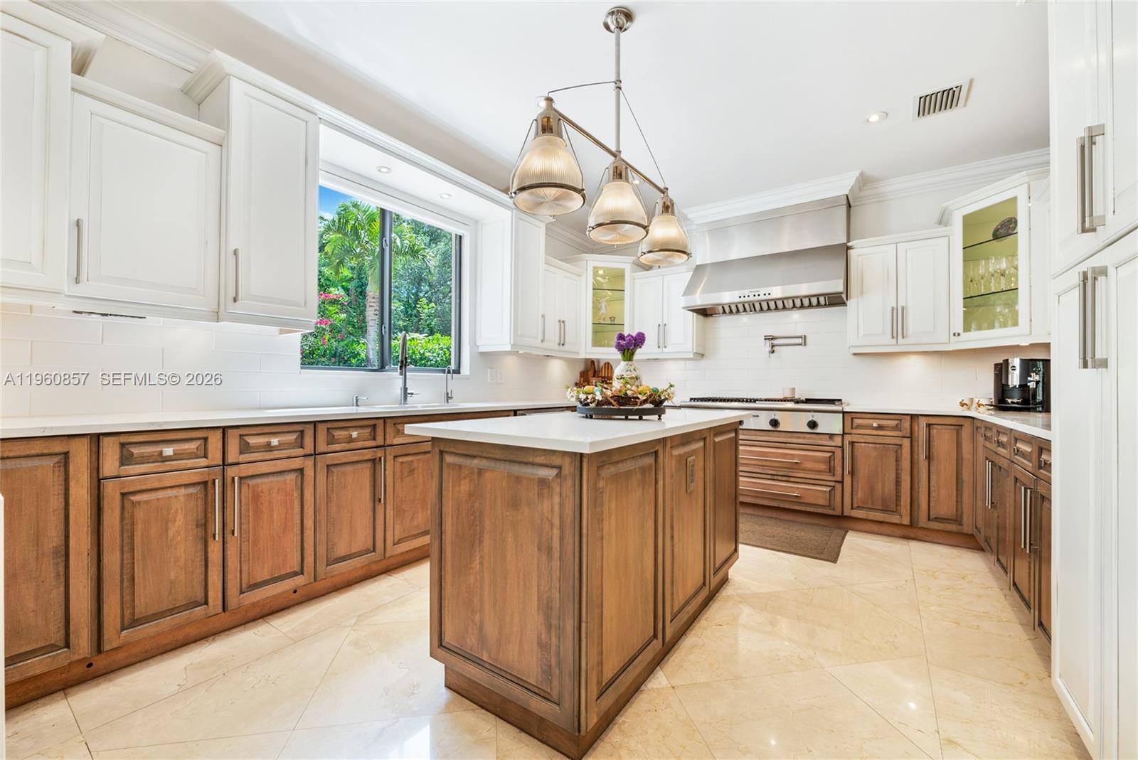 5621 Southwest 68th Court Miami, FL 33143 - Photo 10 of 18 a kitchen with granite countertop a sink window and cabinets
