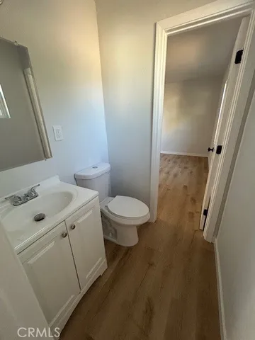 a bathroom with a sink a toilet a mirror and vanity
