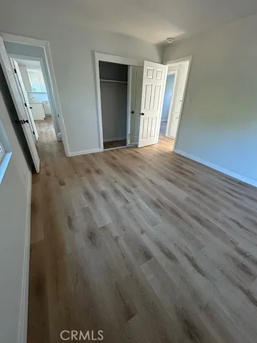 a view of a livingroom with wooden floor and stairs