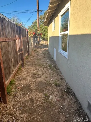 a view of a backyard with wooden fence