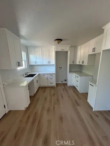 a kitchen with stainless steel appliances a refrigerator sink and cabinets