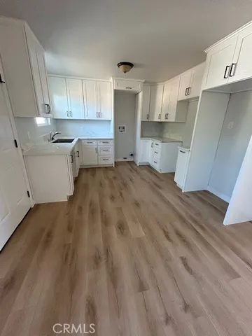 a view of a kitchen with a sink and cabinets