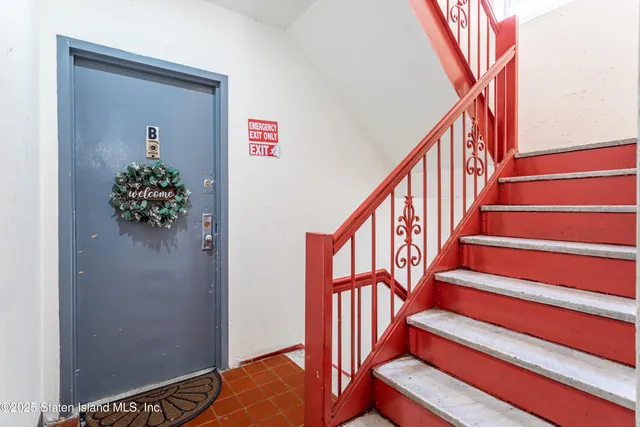 a kitchen with granite countertop a sink stainless steel appliances and white cabinets