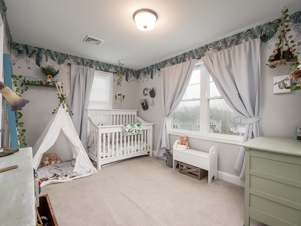 66 Oak Street, Unit 66 Clinton, MA 01510 - Photo 14 of 26 a bedroom with furniture and a window