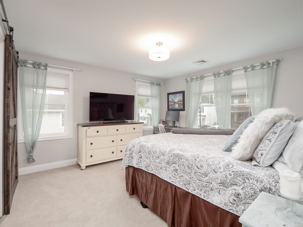 66 Oak Street, Unit 66 Clinton, MA 01510 - Photo 16 of 26 a bedroom with a bed and flat screen tv