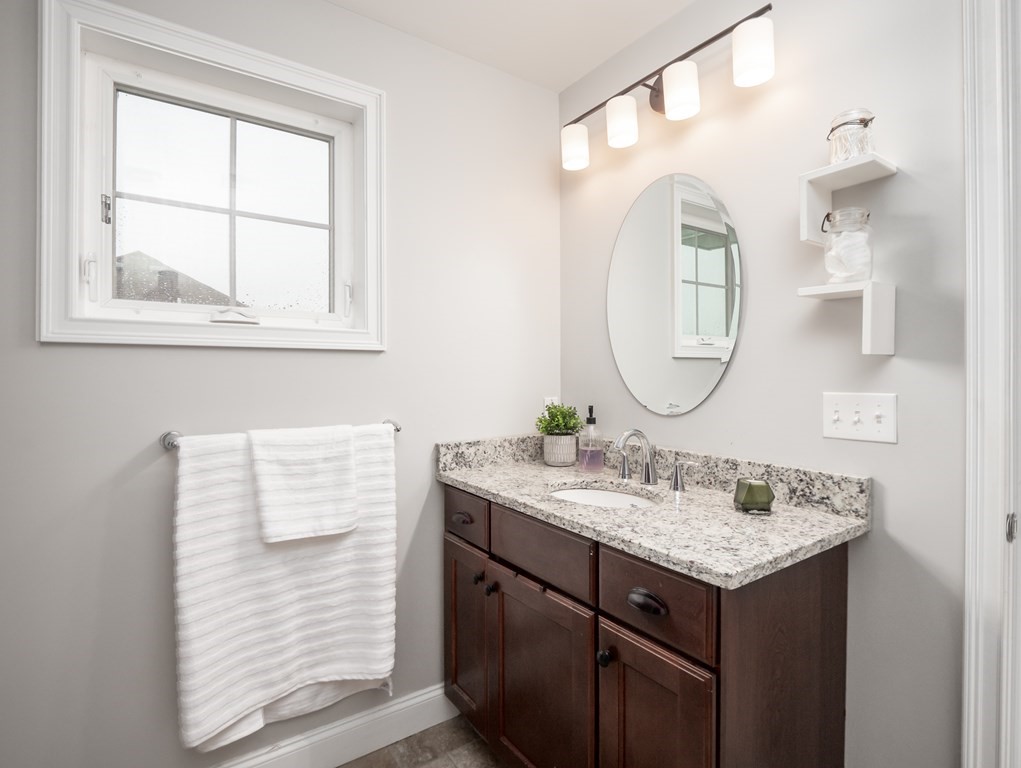 66 Oak Street, Unit 66 Clinton, MA 01510 - Photo 19 of 26 a bathroom with a sink vanity and a mirror