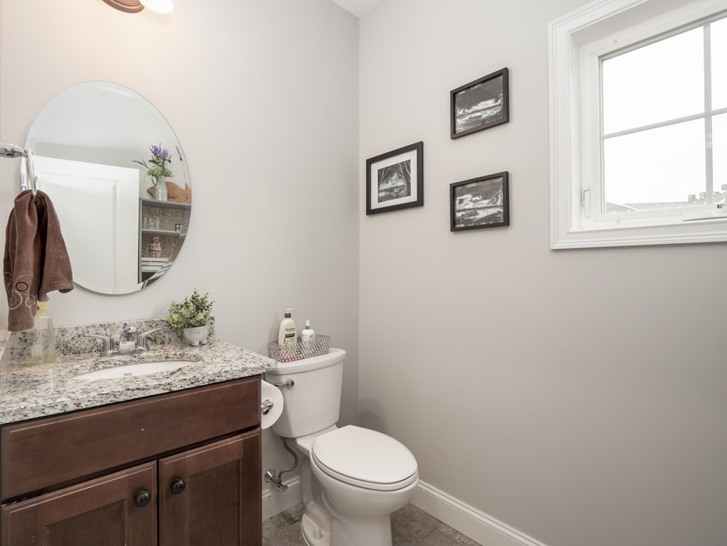 66 Oak Street, Unit 66 Clinton, MA 01510 - Photo 6 of 26 a bathroom with a toilet a sink and mirror