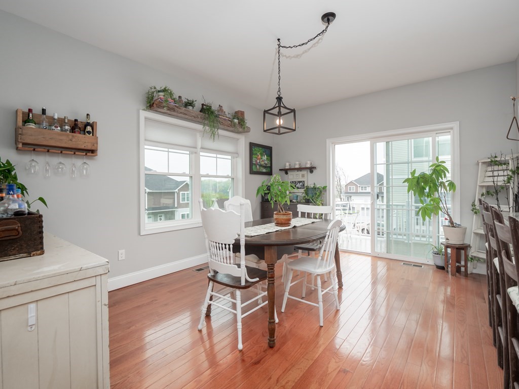 66 Oak Street, Unit 66 Clinton, MA 01510 - Photo 7 of 26 a view of a dining room with furniture window and wooden floor