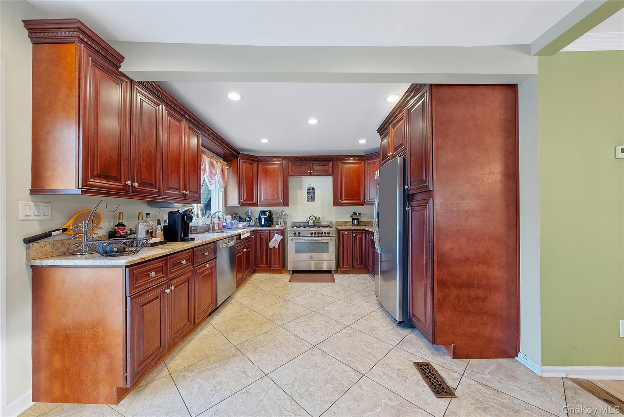 80 George Street Babylon, NY 11702 - Photo 15 of 41 a large kitchen with stainless steel appliances granite countertop a large counter top a sink and a refrigerator