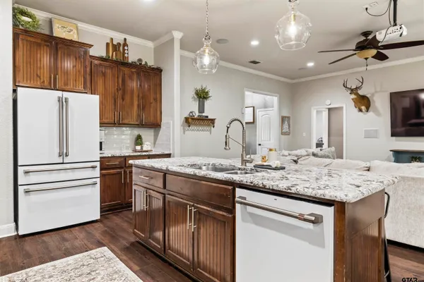 a kitchen with stainless steel appliances granite countertop a sink stove and refrigerator