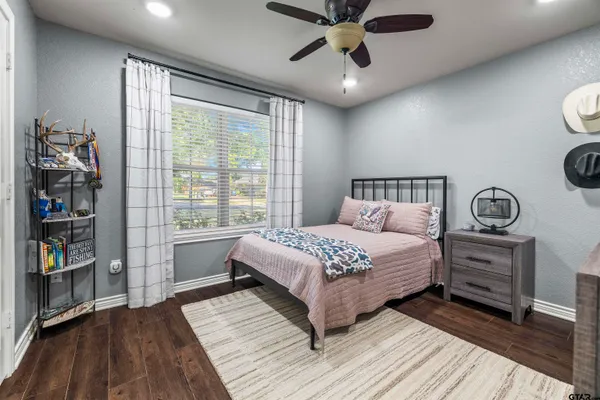 a bedroom with a bed and a large window