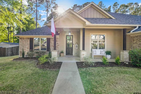 a view of a brick house with a large windows and a yard