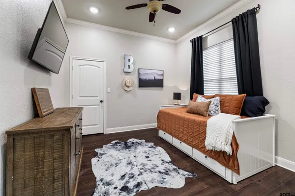 a bedroom with furniture and a flat screen tv