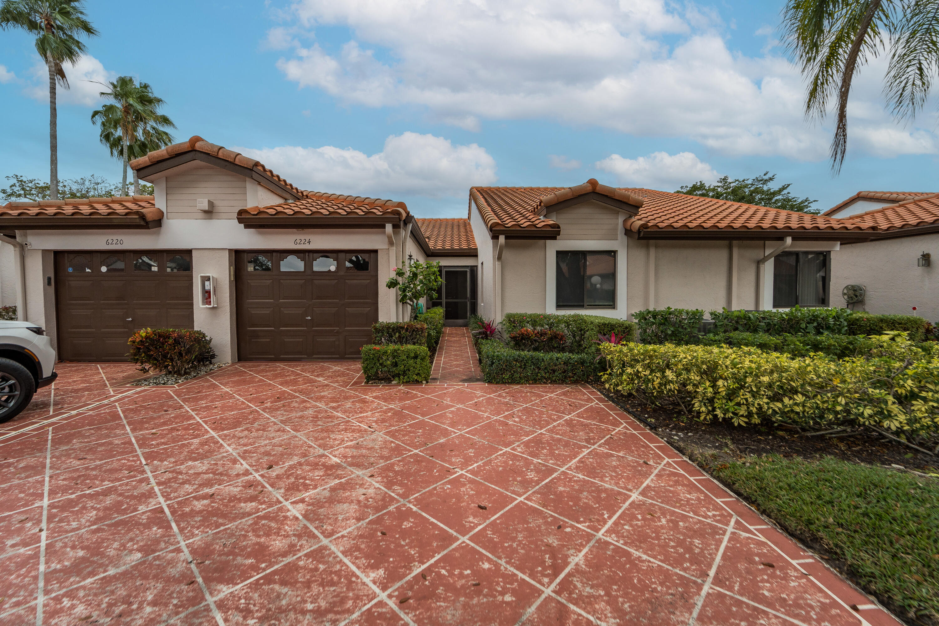 a front view of a house with a yard and a garage