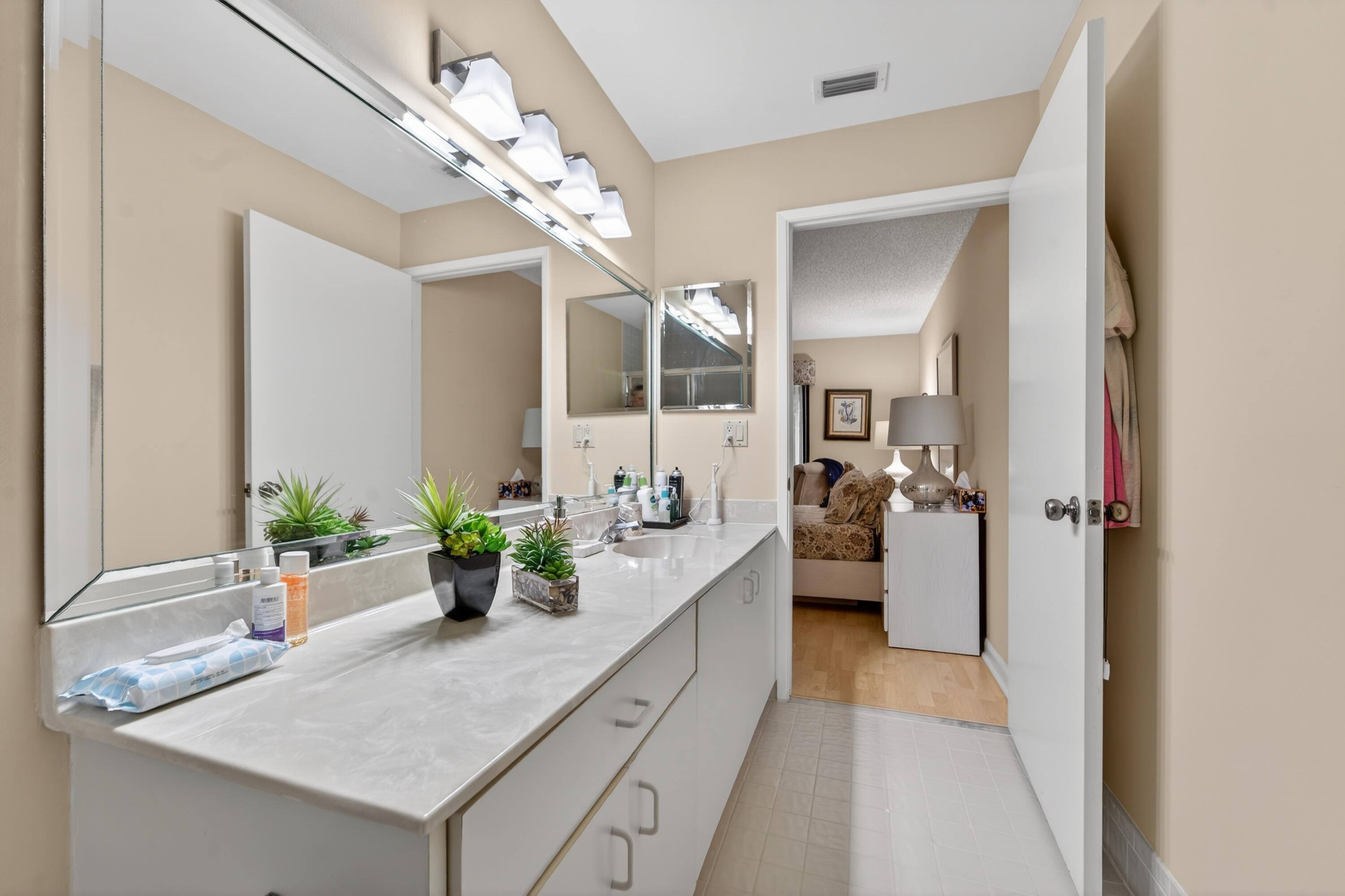 6224 Kings Gate Circle Delray Beach, FL 33484 - Photo 12 of 53 a large white kitchen with a granite countertop sink and a mirror