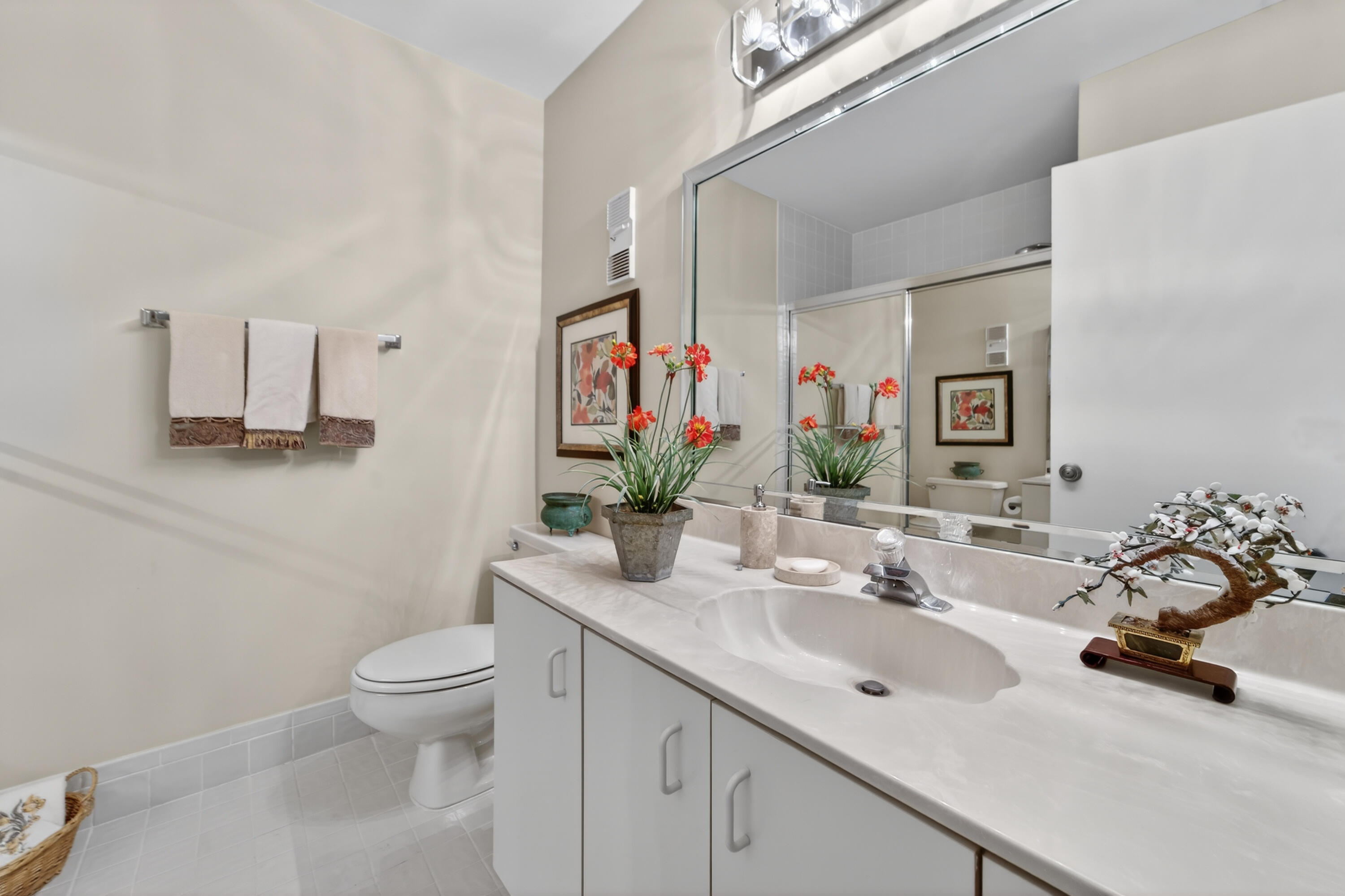 6224 Kings Gate Circle Delray Beach, FL 33484 - Photo 13 of 53 a bathroom with a toilet sink and mirror