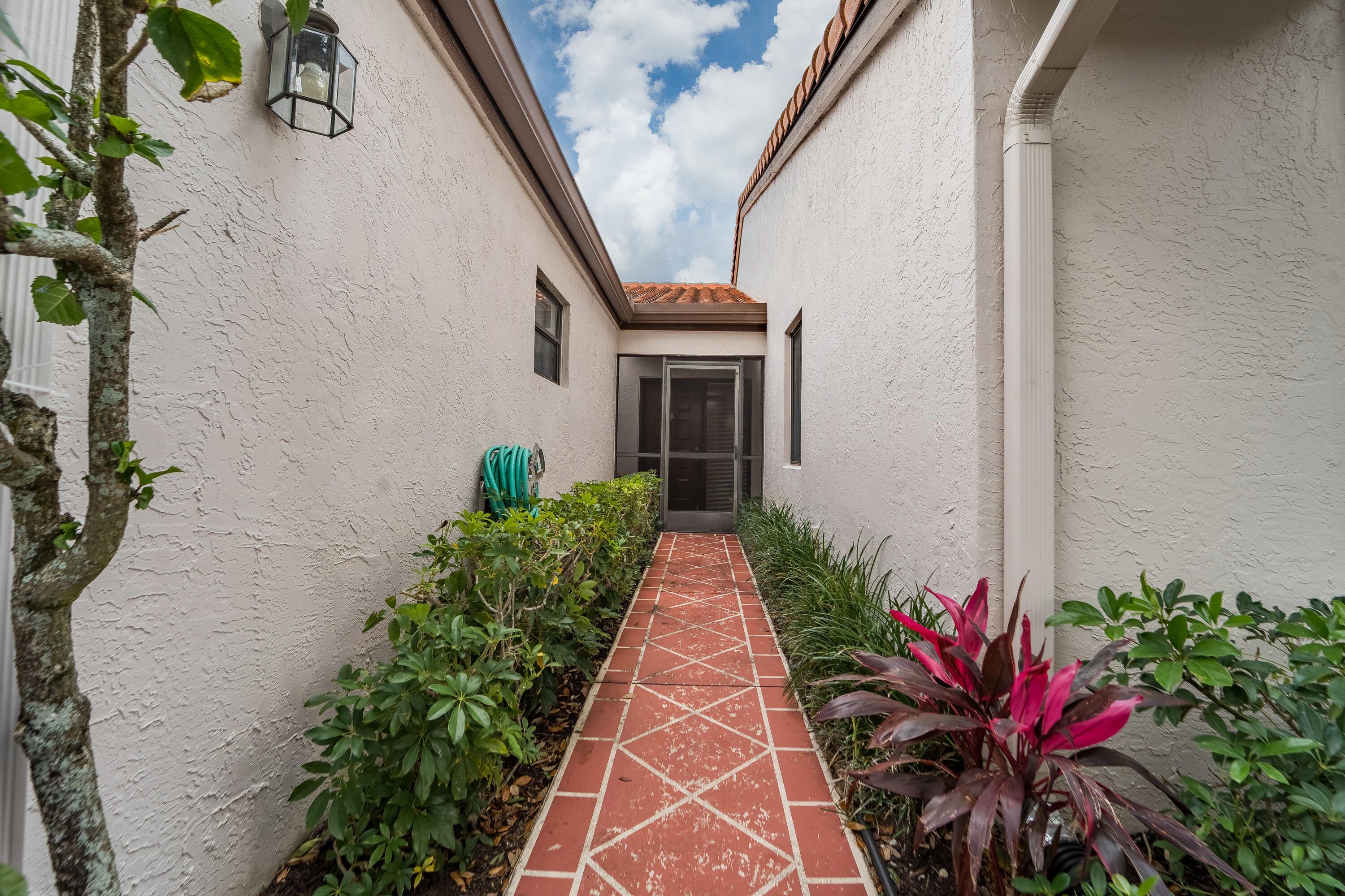 6224 Kings Gate Circle Delray Beach, FL 33484 - Photo 47 of 53 a potted plant sitting in front of a house